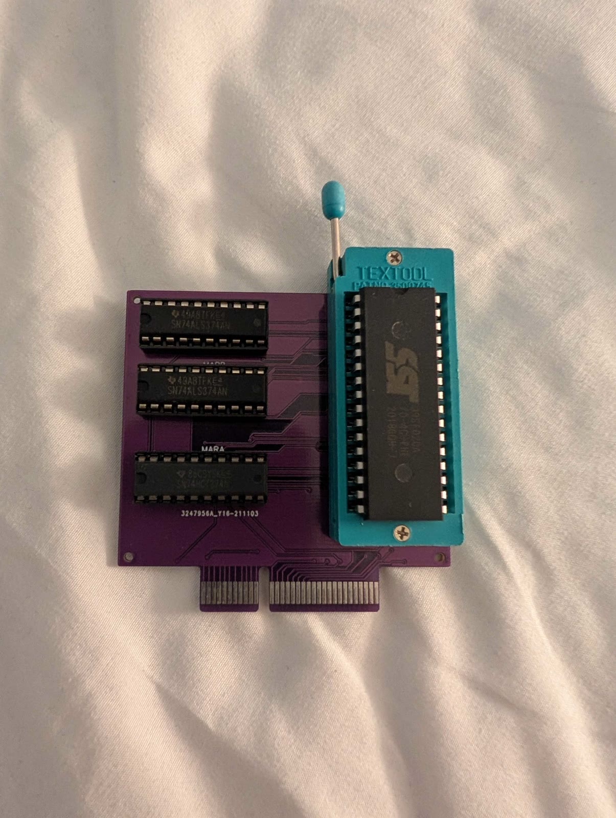The cartridge card, with a ZIF socket and three latch chips